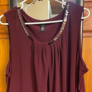 Sleeveless beautiful blouse with bling around the neck.